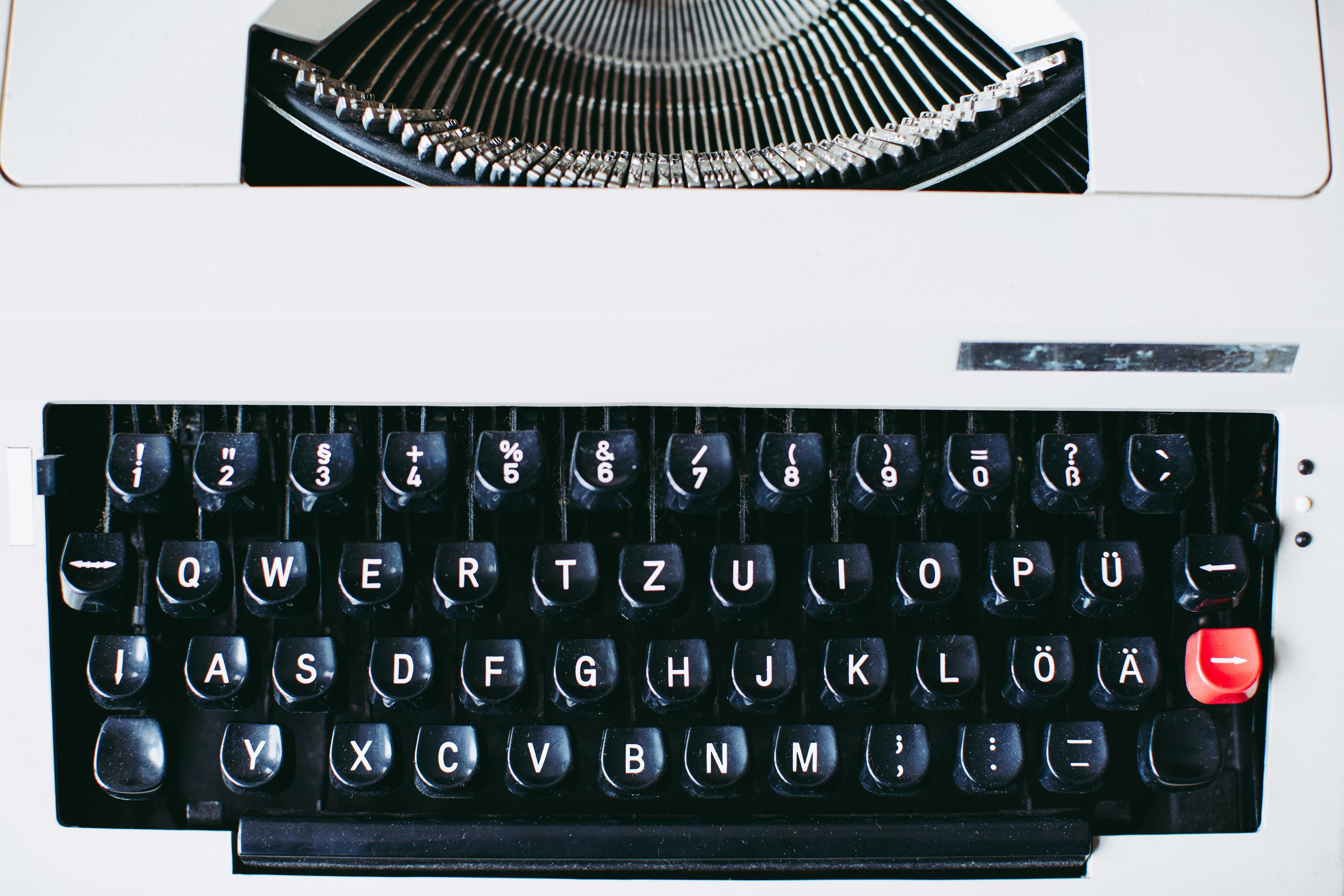 black and white typewriter on white table